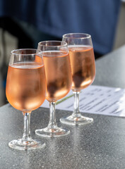 Tasting of white , rose, young dry wine made on Moselle river valley in Germany or Luxembourg, view on terraced vineyards