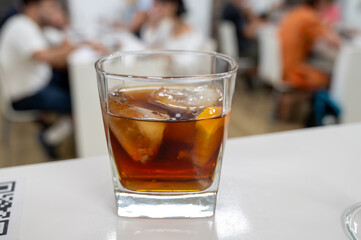 Tasting Sherry sweat cream wine on ice rocks, jerez fortified wine made from palomino white grape served in Jerez de la Frontera, Cadiz, Andalusia, Spain
