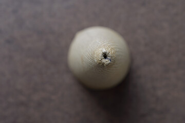top down view of a stiff cardboard spool or thread cone with extreme bokeh