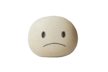 Sad face symbol crafted with a minimalist design, showcasing a frown against a textured, peeling white wall background