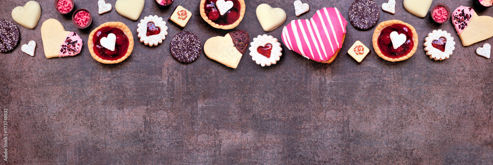 Poster valentines day baking and sweets top border with a variety of cookies, chocolates and sweet treats. 