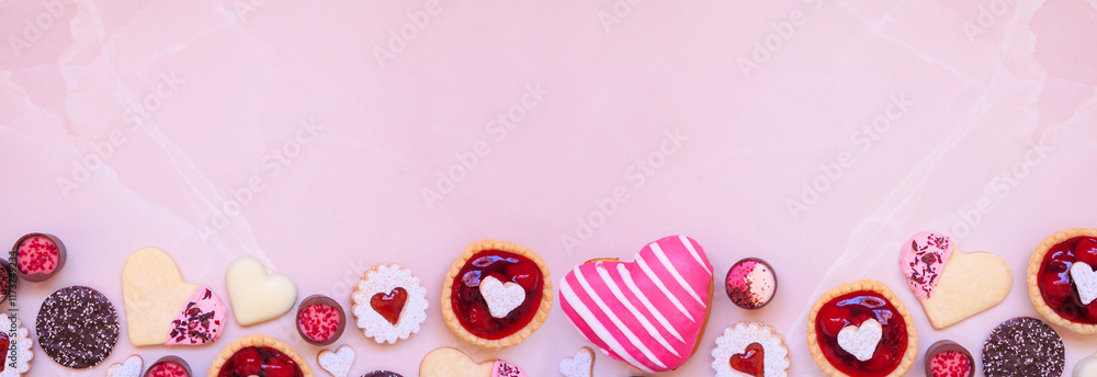 Poster valentines day baking and desserts bottom border with a variety of cookies, chocolates and sweet tre