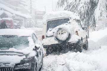 Parked car covered with snow  during snow storm