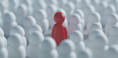 Red wooden figure stands out from the white crowd on gray background, business concept for leader or worker in the workplace.