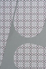 paper stencil with rounded elements on paper with geometric line/floral patterns