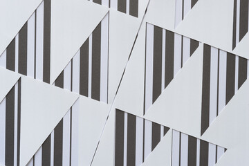 paper with triangle cutouts on paper with bold stripes