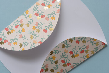 machine-cut paper shape with folds or flaps on blue paper