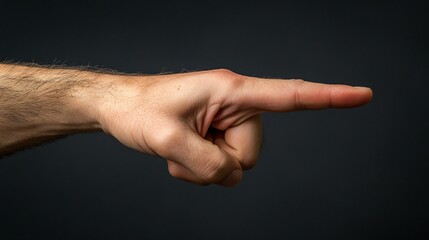 Pointing hand gesture against a dark background emphasizing direction and purpose