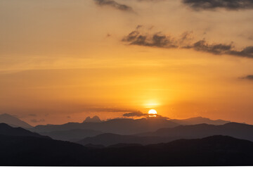 Orange sunset with the silhouette of the mountains