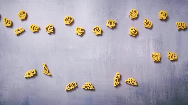 Animal and dinosaur shapes made of pasta. Gluten-free pasta for children. Uncooked Pasta playing on the table. Different types and shapes of pasta. 