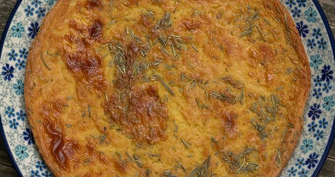 Chickpea pancake Farinata Ligure. Homemade traditional Italian cuisine dish. Top view, table spin. 