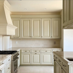 a view of painted kitchen cabinets the color of a extremely pale green and cream mixed paint with cream colored walls