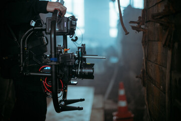 Professional cinema and video camera on the set. Shooting shift, lighting fixtures, shooting equipment and the team. Technique of modern filming and advertising.