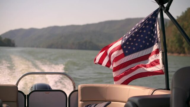 American Flag on Boat at Watauga Lake, USA vibrant American flag flutters in wind on boat cruising through serene Watauga Lake surrounded by scenic hills in USA American flag flutters in wind