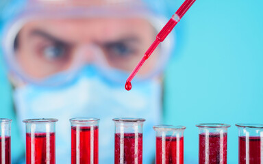 Blood test in clinic. Doctor works with patient's blood sample in lab. Serological testing in...