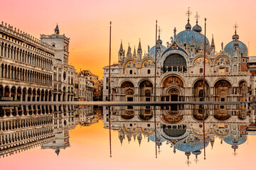 June 25, 2019. Venice, Italy. Sunrise in San Marco square with Campanile and San Marco's Basilica. The main square of the old town. Venice, Veneto Italy. Reflection on the flooded square.