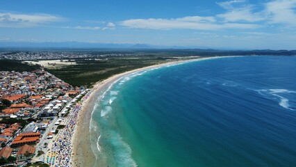Aerial drone view of Peró Beach, Cabo Frio, Rio de Janeiro, Brazil, during summer, bustling with...