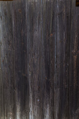 Naklejka premium A close-up of weathered, dark gray wooden planks forming a textured surface