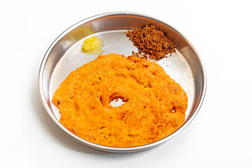 Traditional Indian dosa served with country sugar and ghee on a plate, top view