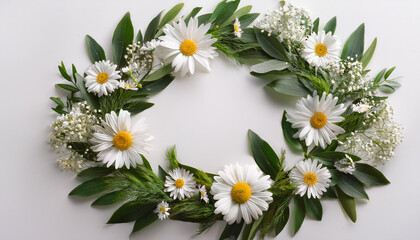 Fototapeta premium a white flower wreath with green leaves and daisies