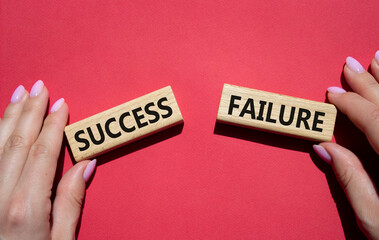 Success or Failure symbol. Concept word Success or Failure on wooden blocks. Businessman hand. Beautiful red background. Business and Success or Failure concept. Copy space