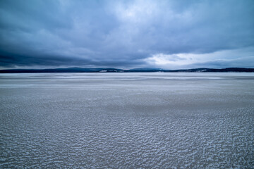 Wide-angle landscape view of the frozen rural lake Lipno.