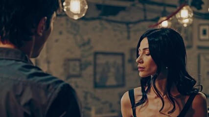 Elegant woman enjoying drinks in a cozy bar with vintage decor in the evening hours