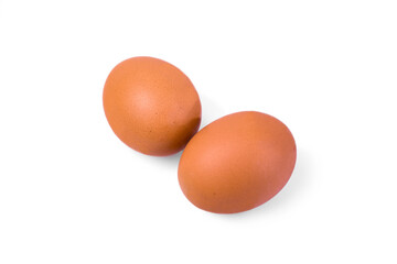 Two brown eggs on a white background