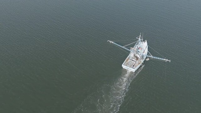 Aerial view of a shrimp boat pulling nets off the coast of South Carolina near Beaufort.