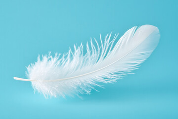 White feather flying on blue background. Abstract bird feather falling on color background. Symbol of peace or freedom concept. Generated AI