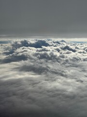 Naklejka premium Somewhere above the white and grey clouds 
