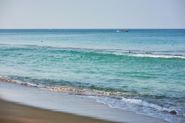 Serene Ocean View With Calm Waves and a Distant Boat on Tranquil Water