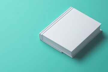 White blank book on teal background.