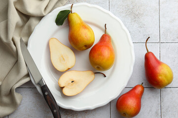 Ripe juicy pears on light tiled table, flat lay