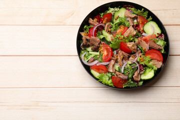 Delicious fresh tuna salad on wooden table, top view. Space for text