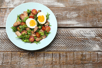 Delicious fresh tuna salad on wooden table, top view. Space for text
