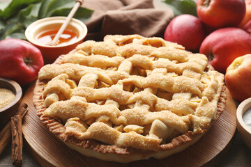 Tasty homemade apple pie and ingredients on table, closeup