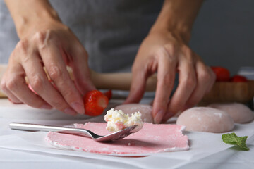 Woman making tasty mochi at table, closeup