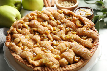 Homemade apple pie and ingredients on white marble table, closeup