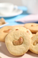 Plate with tasty cashew cookies on table, closeup