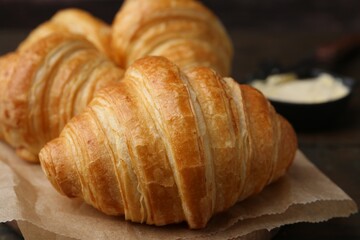 Tasty fresh croissants on table, closeup. Puff pastry