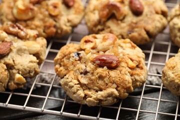 Tasty cookies with nuts on wooden table, closeup