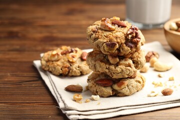 Tasty cookies with nuts on wooden table, closeup