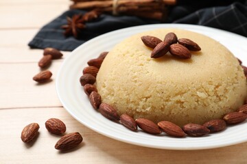 Delicious semolina halva with almonds on white wooden table, closeup