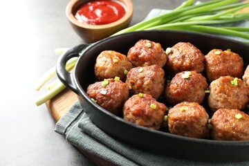 Tasty meatballs served on grey table, closeup