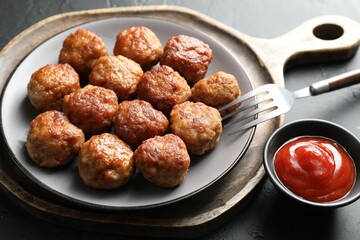 Tasty cooked meatballs served on grey table