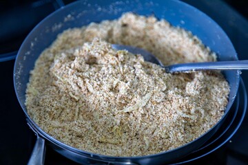 Authentic Brazilian farofa prepared with toasted cassava flour, bacon, onion and typical spices. Brazilian food