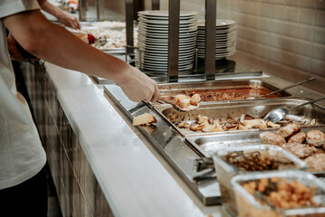 Buffet in hotel restaurant, various food dishes on tray, dinner in dining room