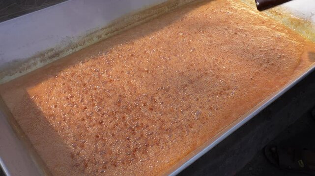 Date jaggery is being prepared from date palm juice