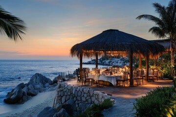 Fototapeta premium Oceanside dining pavilion; sunset, romantic ambiance.
